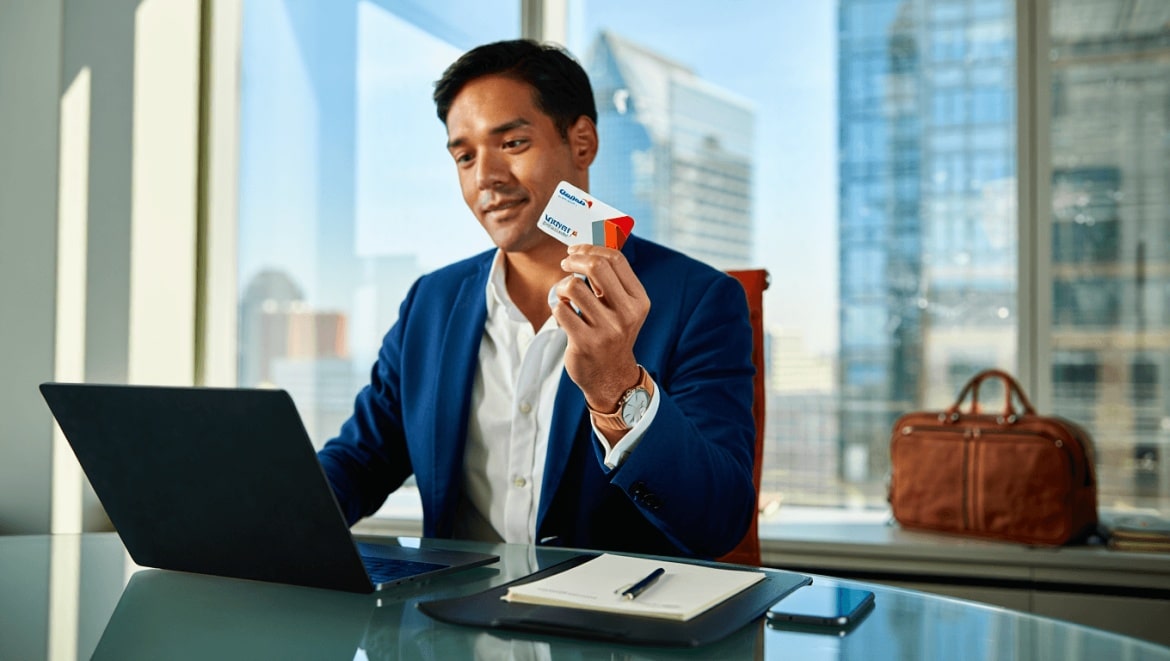 Nomadic Matt holding up his Capital One Venture X card