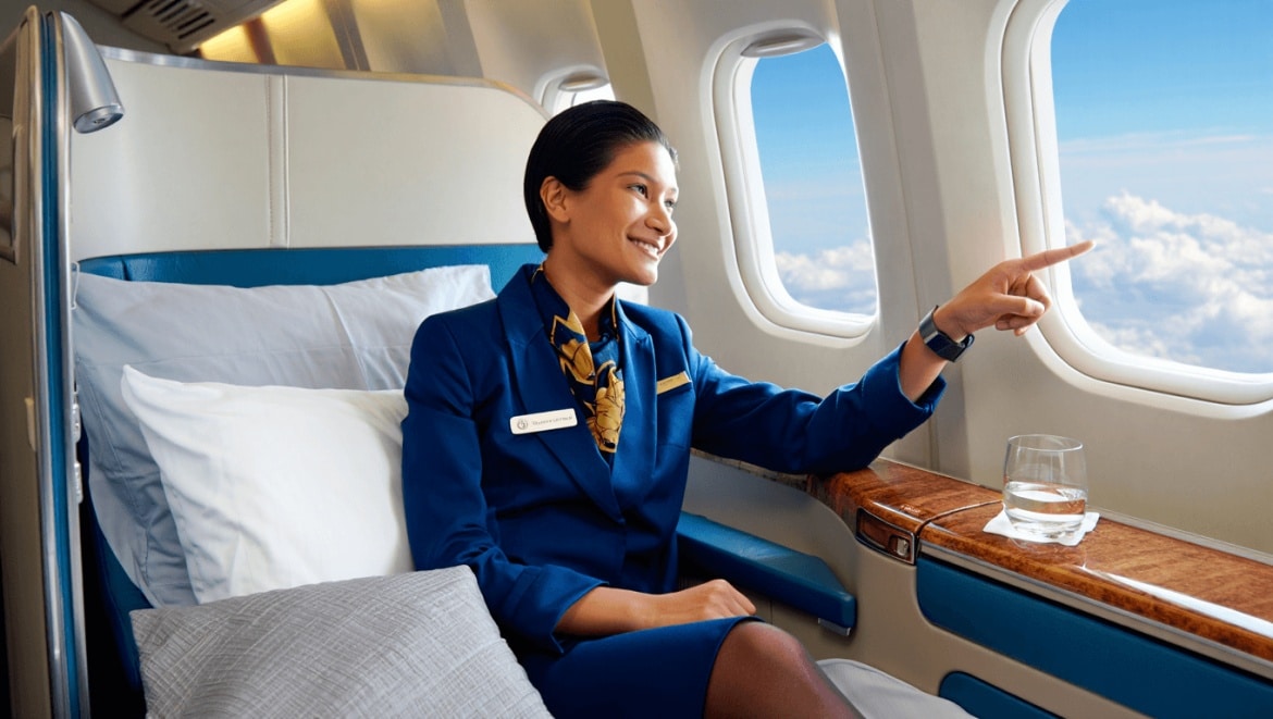Empty airplane cabin with rows of seats and overhead storage compartments visible