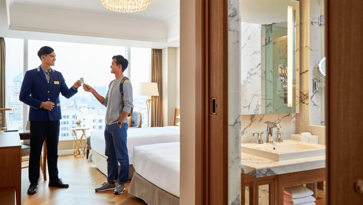 Luxurious bathroom with a freestanding black bathtub by large windows overlooking a scenic landscape