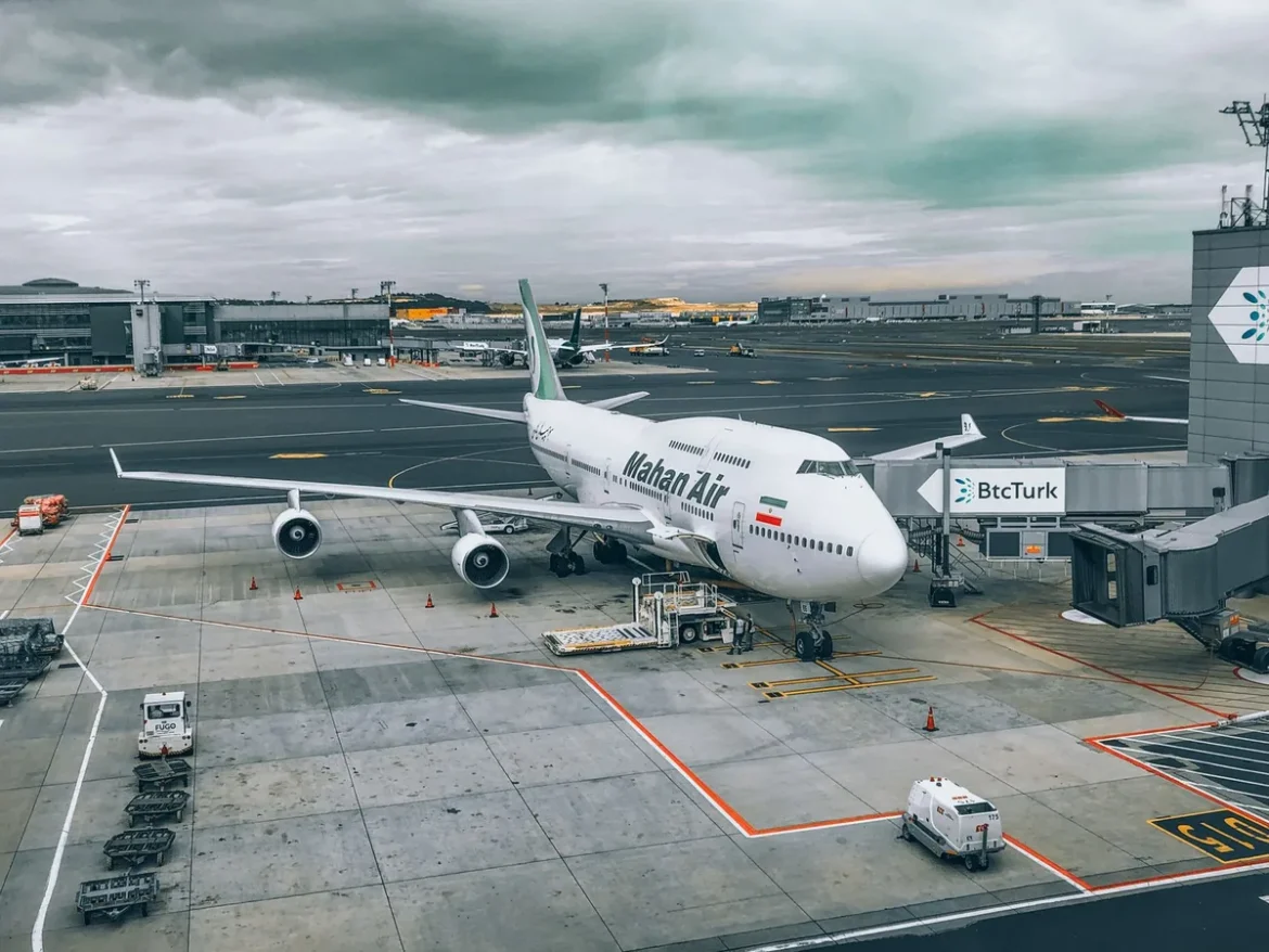 Avion sur le tarmac avec tour de contrôle en arrière-plan et équipe au sol