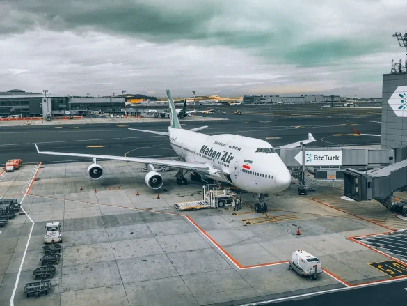 Avion sur le tarmac avec tour de contrôle en arrière-plan et équipe au sol