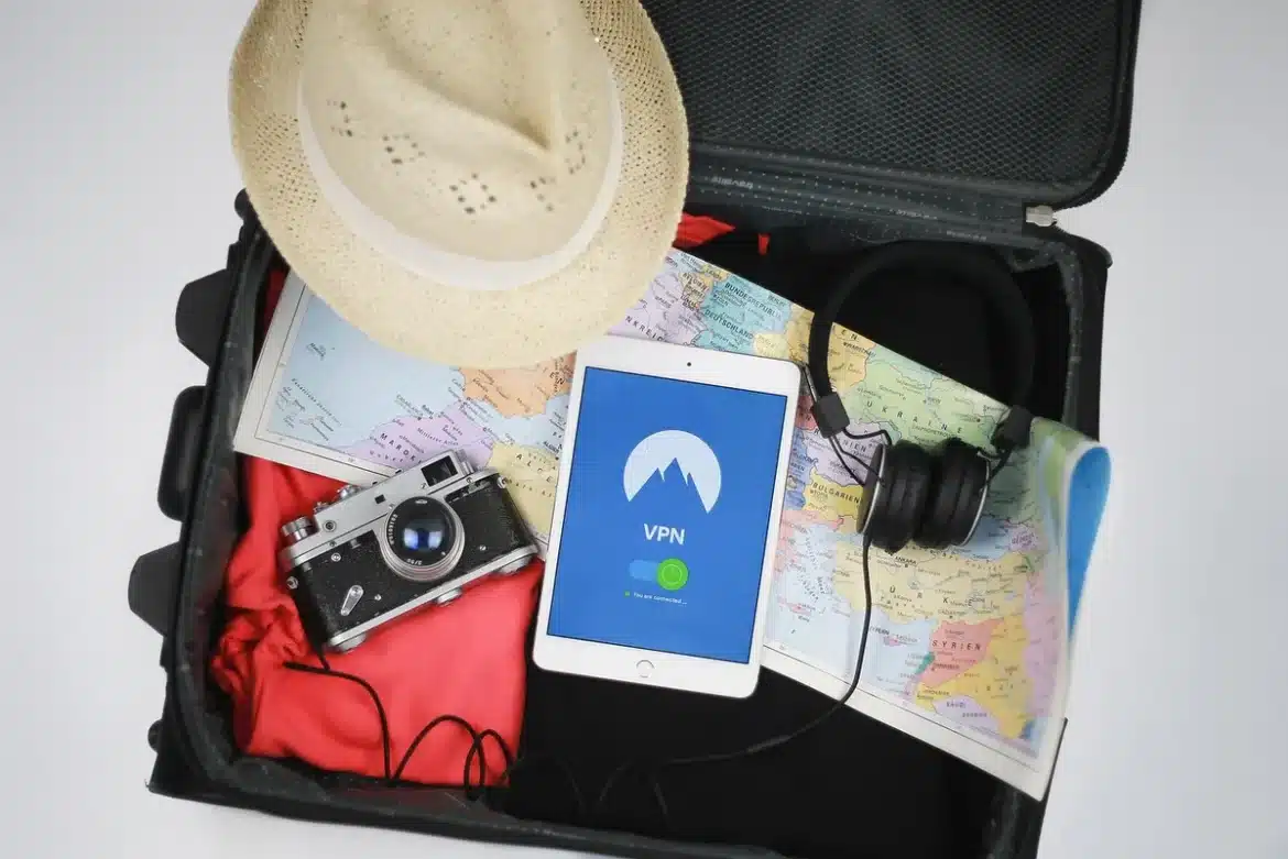 Mains organisant une checklist à côté d'une valise ouverte près d'une fenêtre en plein jour